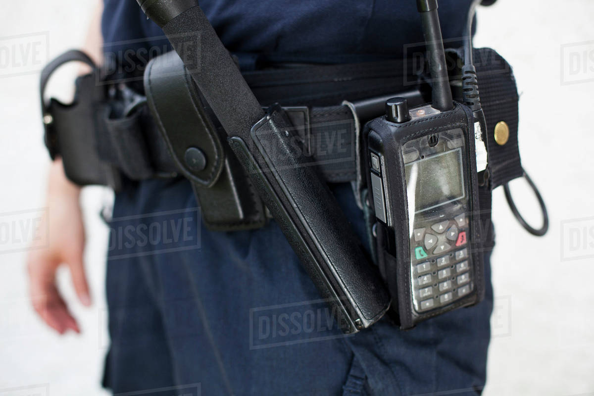 Midsection of a police officer with walkie