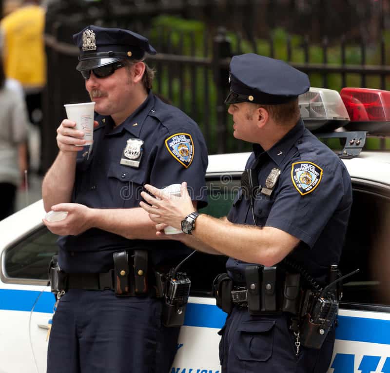Two Police Officers while Drinking a Cup of Coffee in NYC. Editorial ...